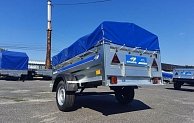 Прицеп Кремень стандарт плюс 2,31*1,31 с бортом 50 см с тентом 70 см